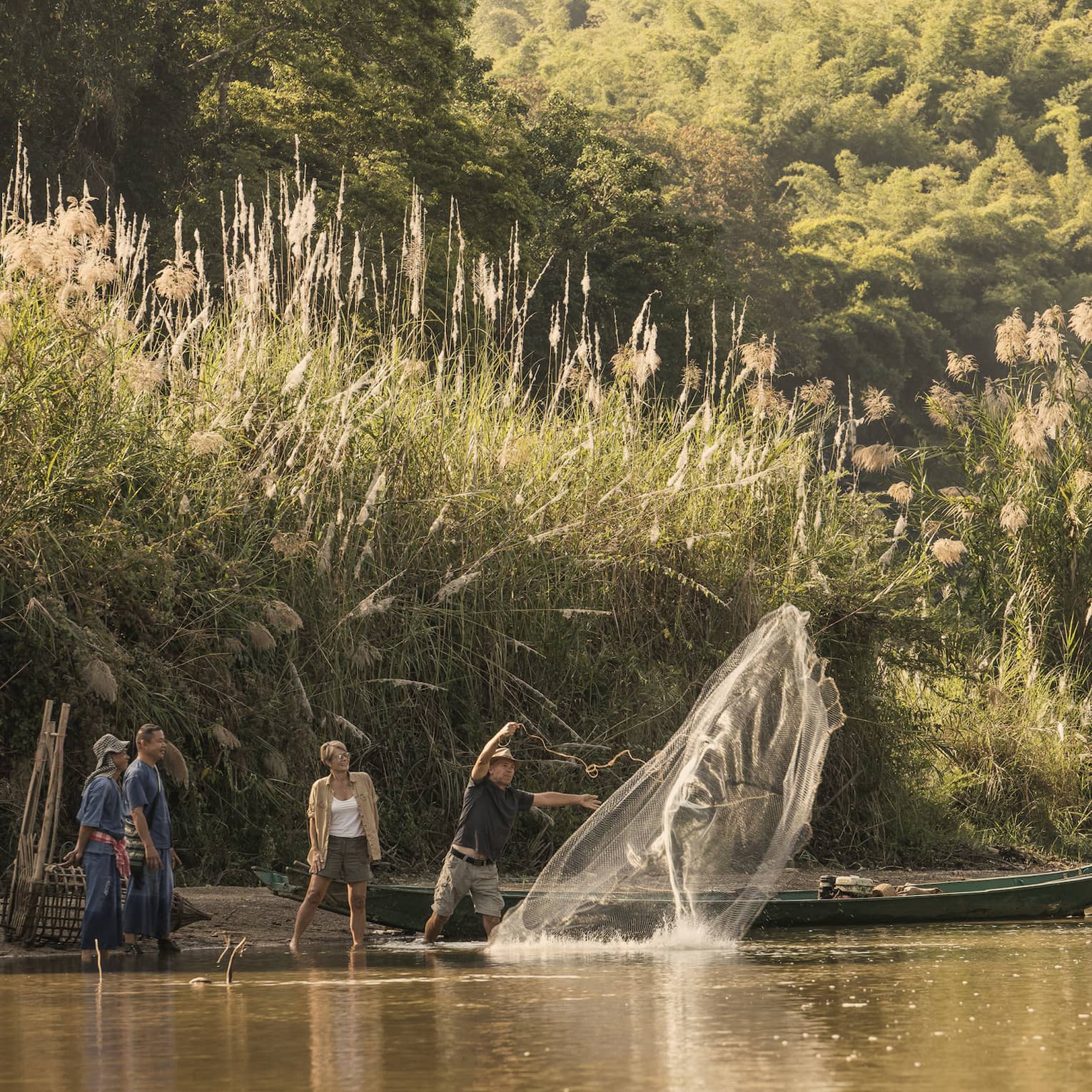 Local fisherman casting net in river during cultural activity